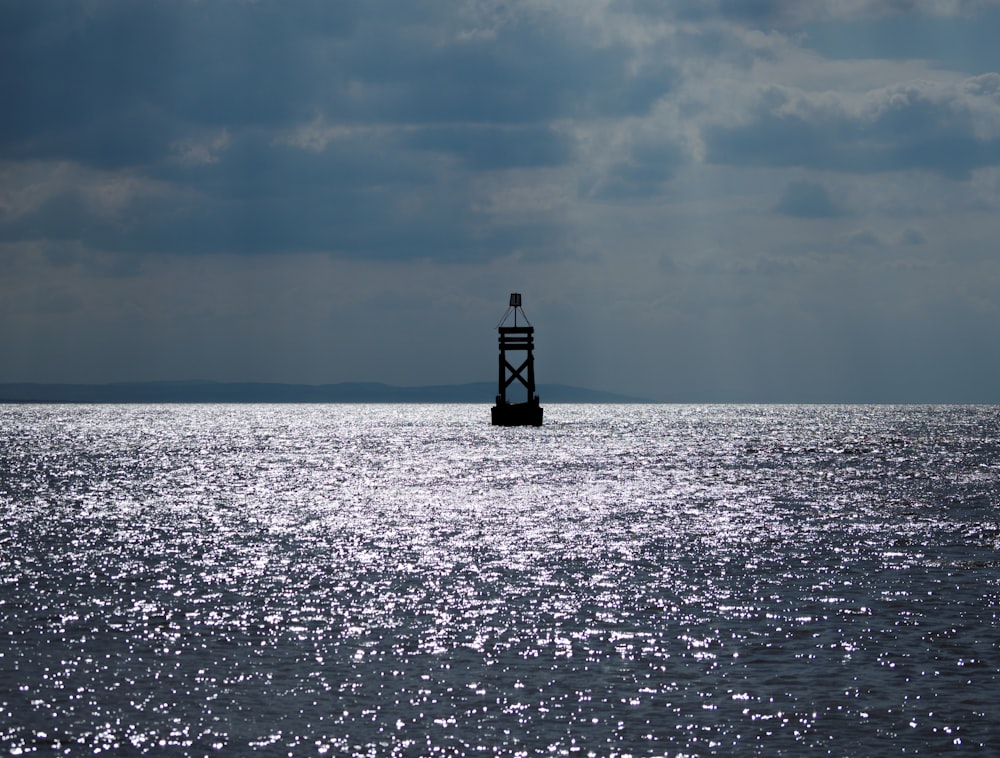 a lighthouse in the middle of a body of water