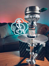 A customer enjoying a smooth hookah session in a stylish, modern lounge setting.