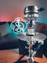 Elegant black and gold themed hookah setup with soft lighting, inviting guests to connect.
