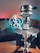 A cozy hookah lounge with comfortable seating and ambient lighting, showcasing a variety of hookah setups on wooden tables.