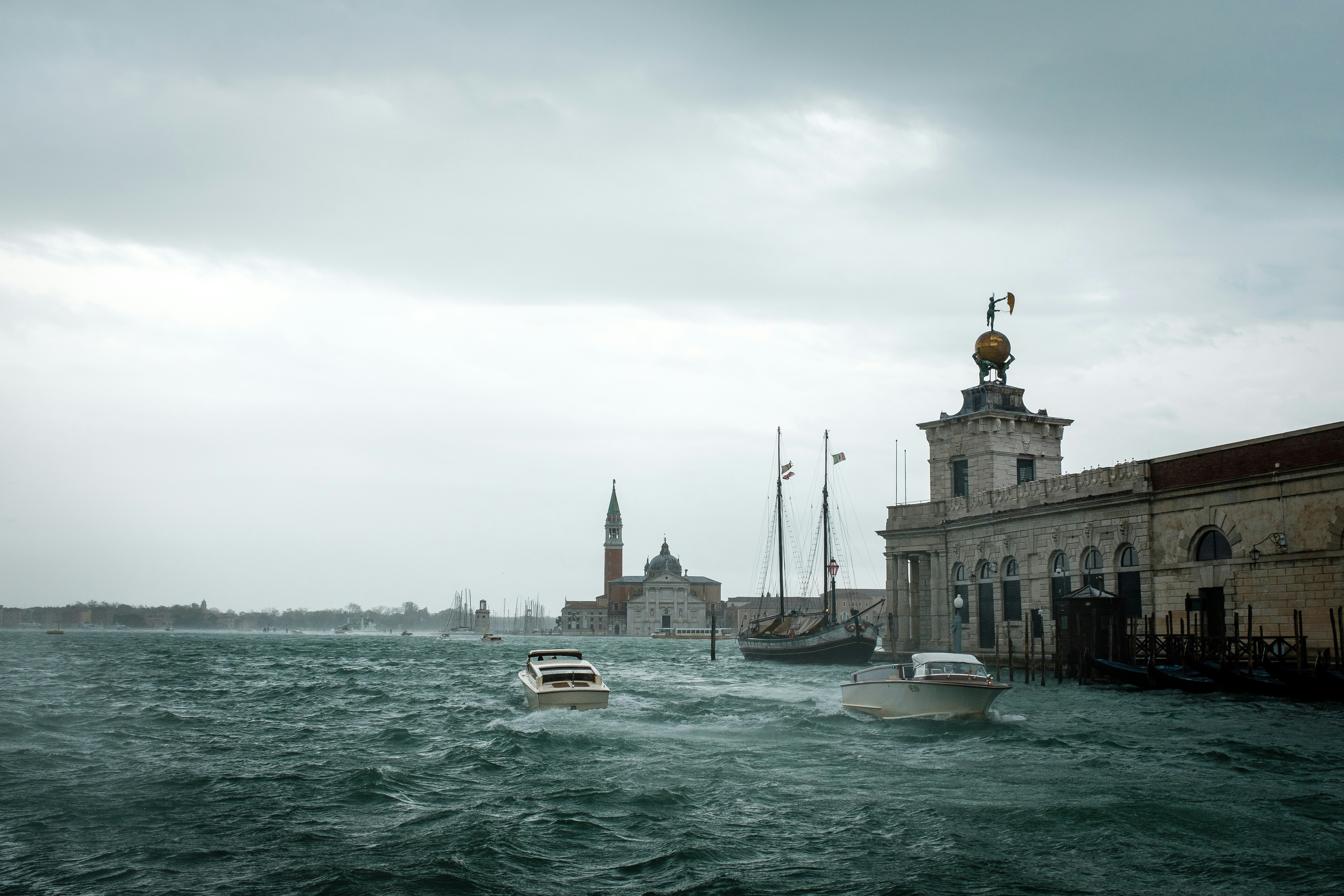 a body of water with boats in it and buildings around it