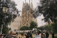 a crowd of people walking in front of a castle