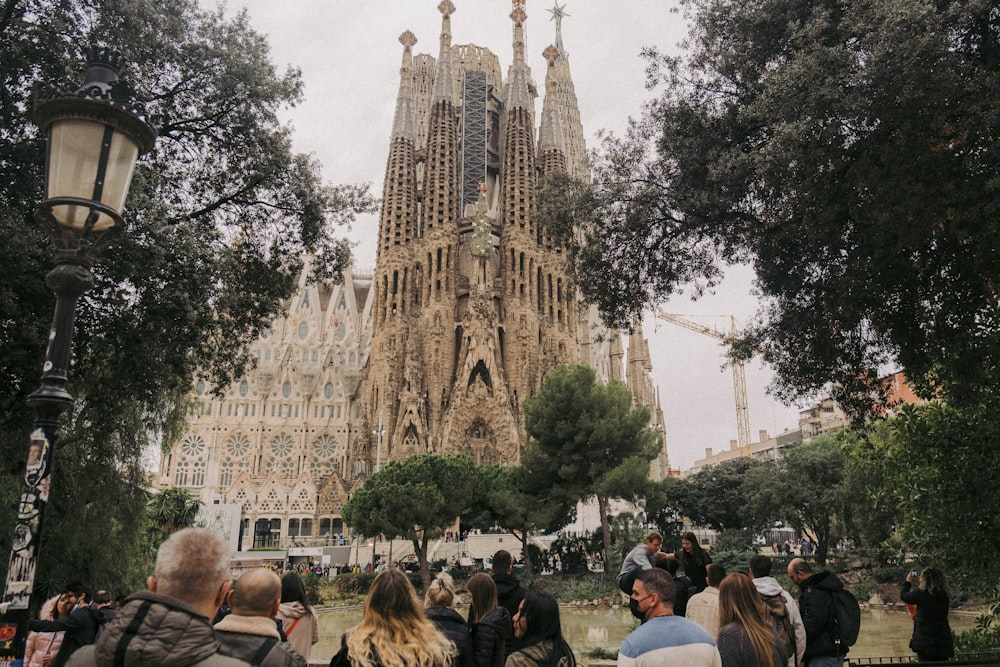 a crowd of people walking in front of a castle