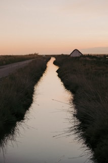 a river with a tent in the distance