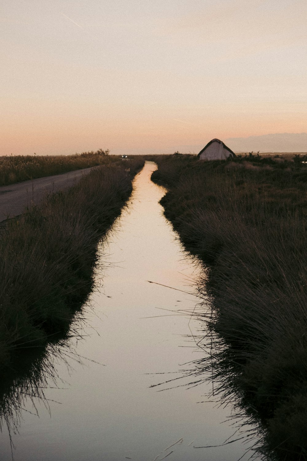 a river with a tent in the distance