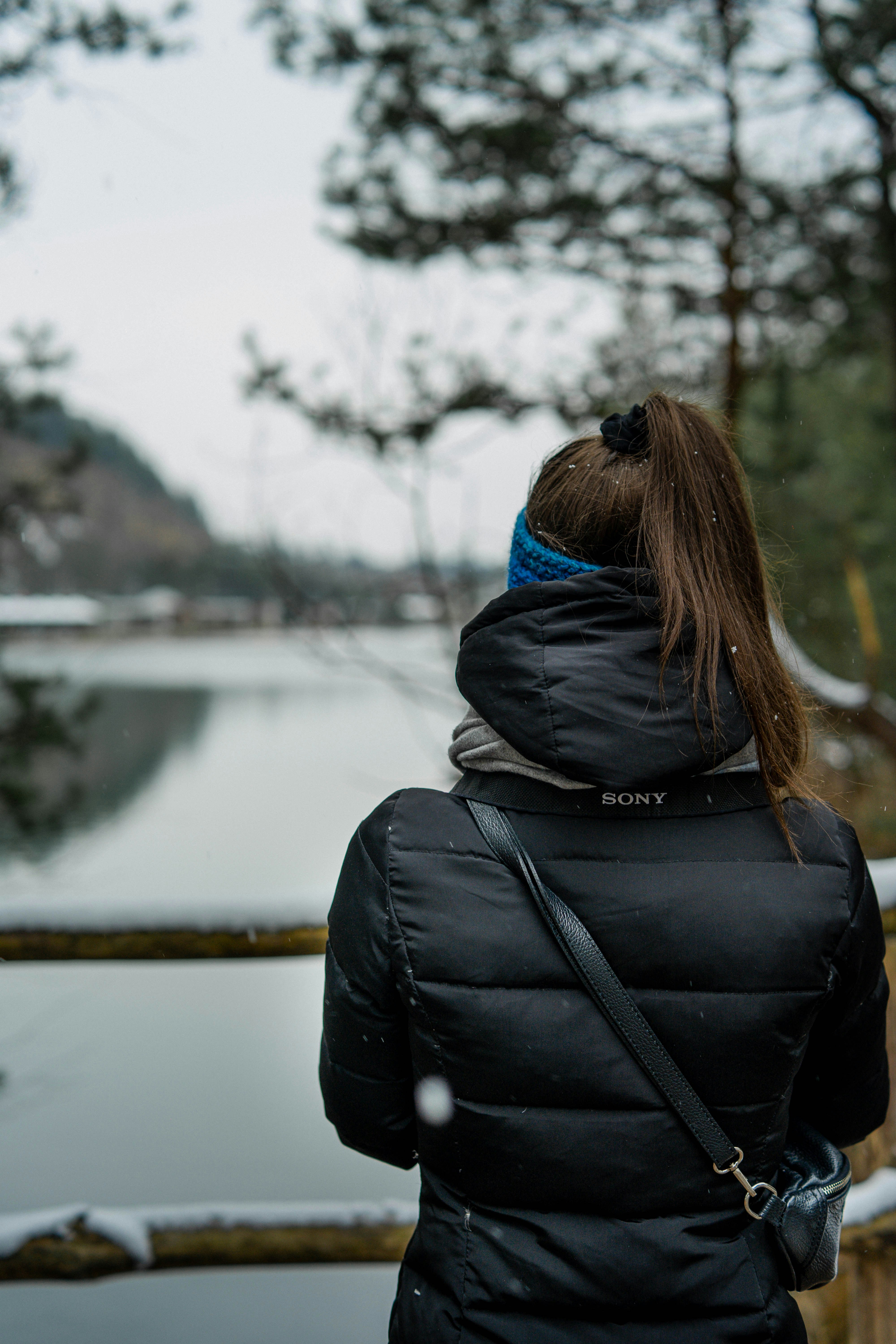 a woman looking at a lake
