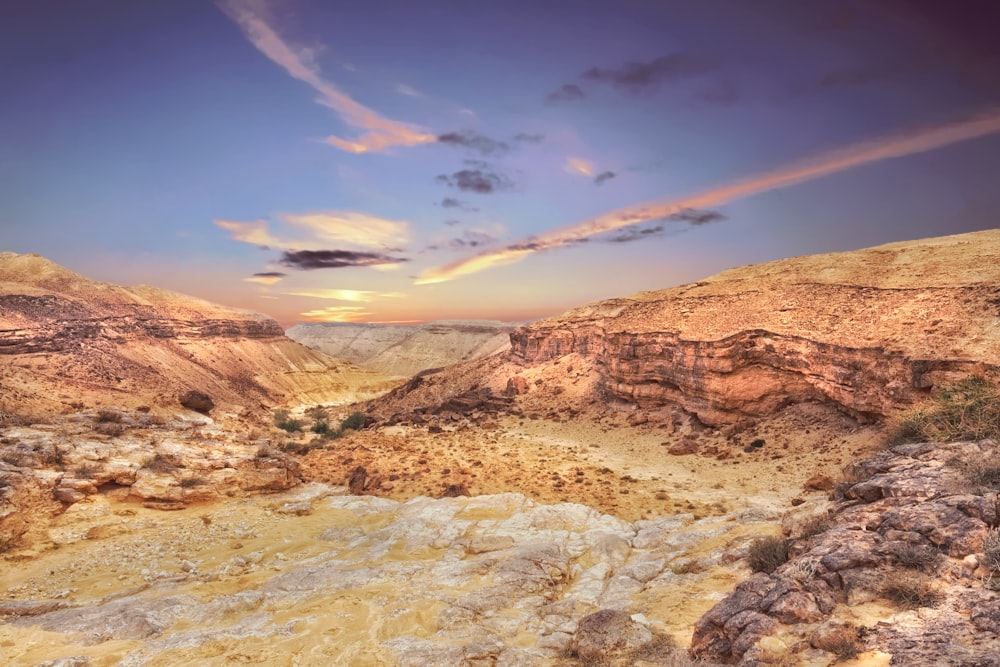 a rocky landscape with a rainbow