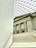 The image features a modern architectural interior combining classical and contemporary elements. A staircase in the foreground leads up to a facade with tall classical columns. The ceiling is a geometric patterned glass roof, allowing natural light to fill the space. Visible inscriptions run vertically along a wall on the left.