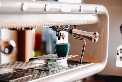 Modern super-automatic coffee machine brewing a rich espresso in a sleek office environment