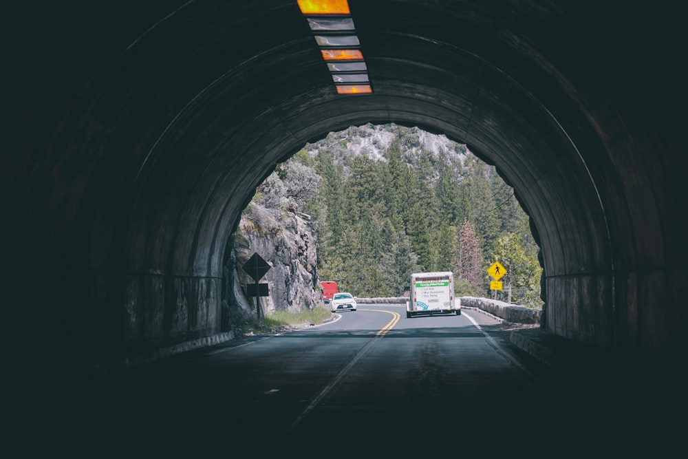 a tunnel with a truck and trees