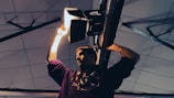 An electrician installing lighting fixtures in a home.