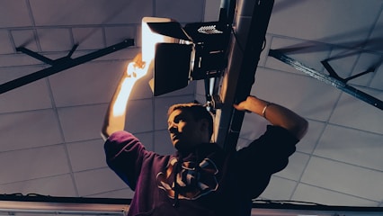 An electrician installing energy-efficient lighting in a commercial building.