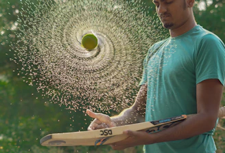 Young cricketer receiving hands-on coaching on batting technique.