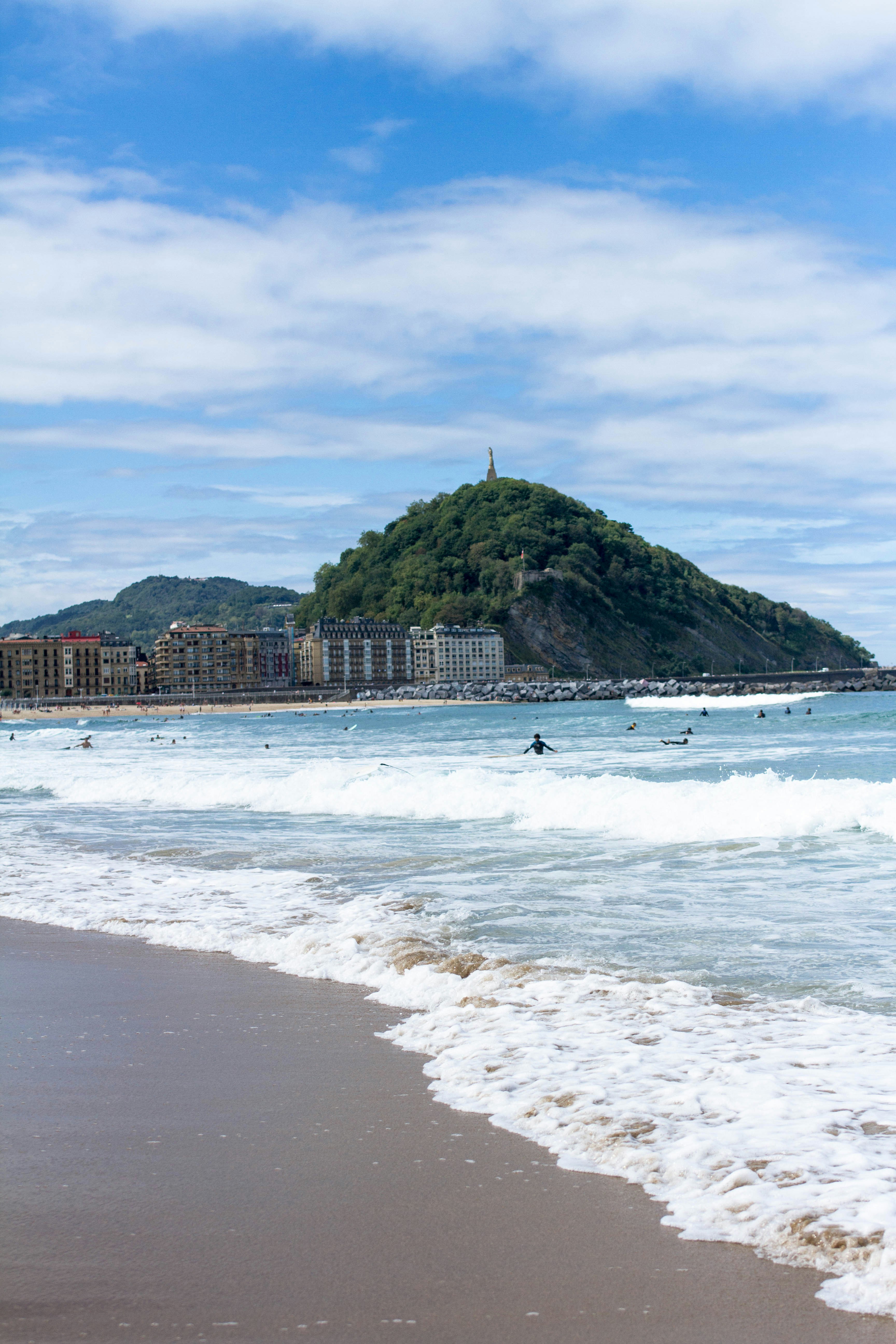 a beach with a hill in the background