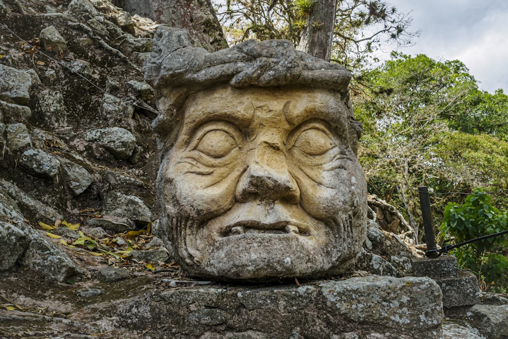 a stone statue of a face