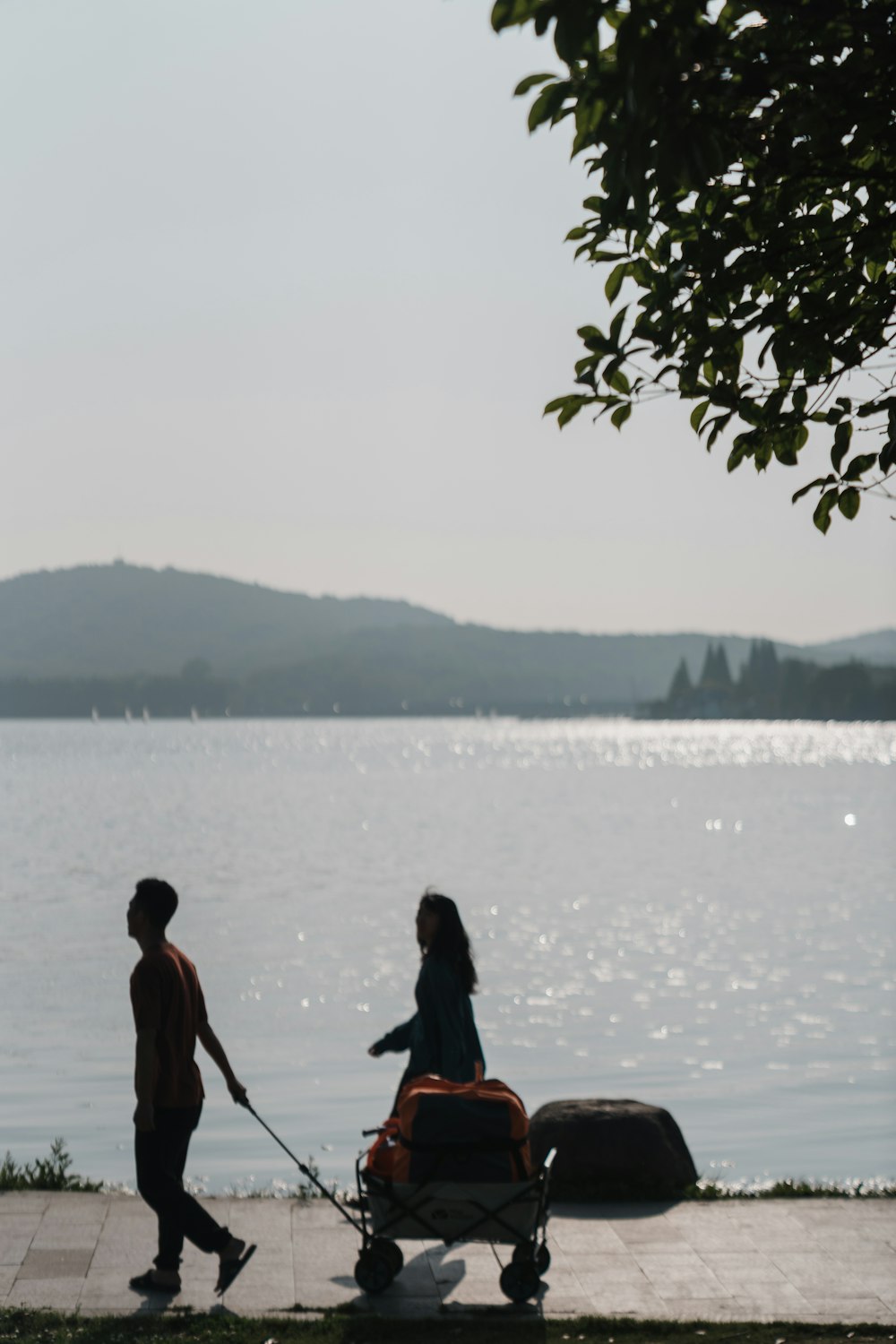 a man and woman walking by a body of water