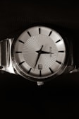 Side profile of a sleek Euro Date watch showcasing its polished stainless steel casing.