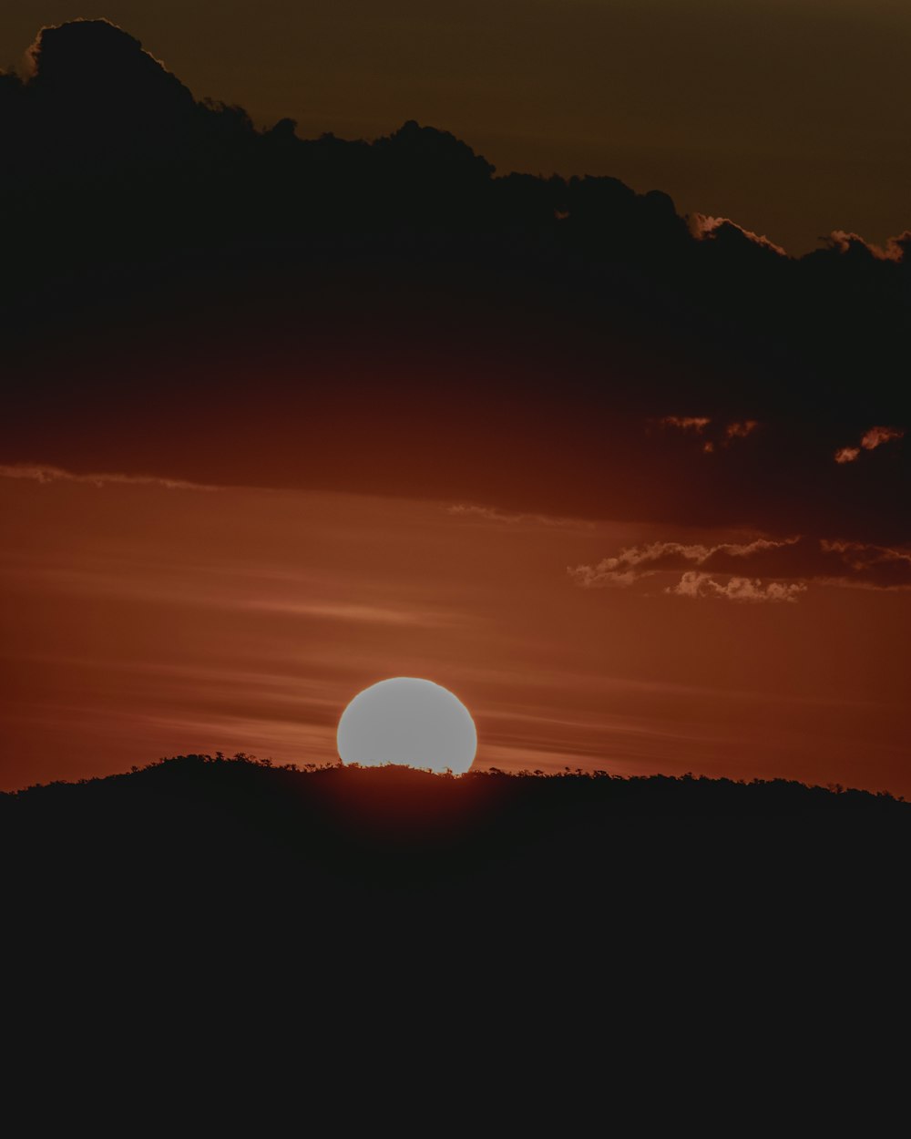 a sunset over a mountain