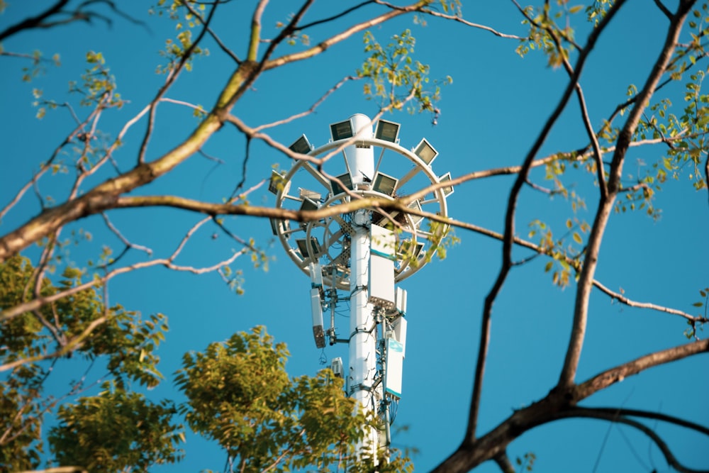 a tall metal tower with trees around it