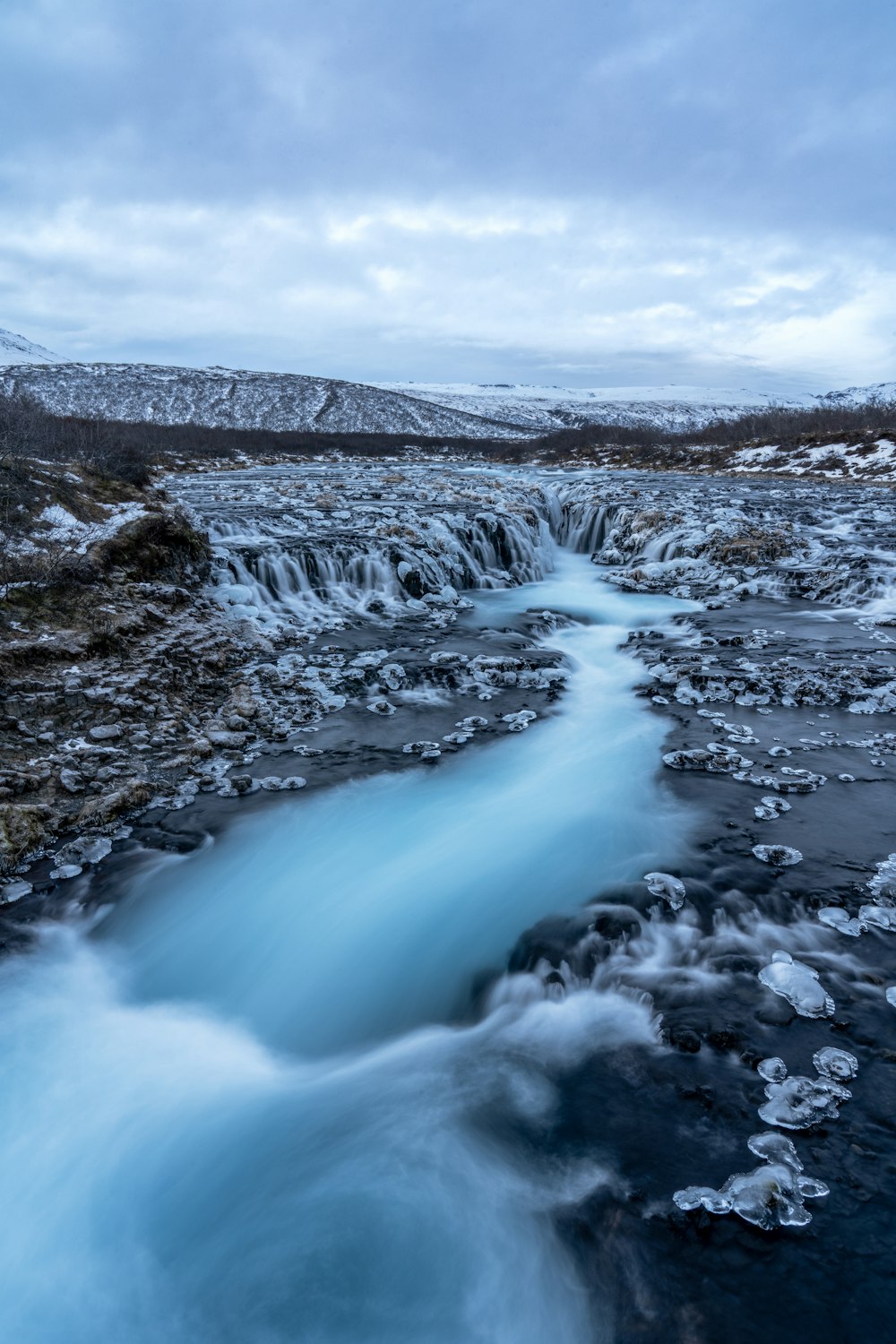 a river with ice and snow