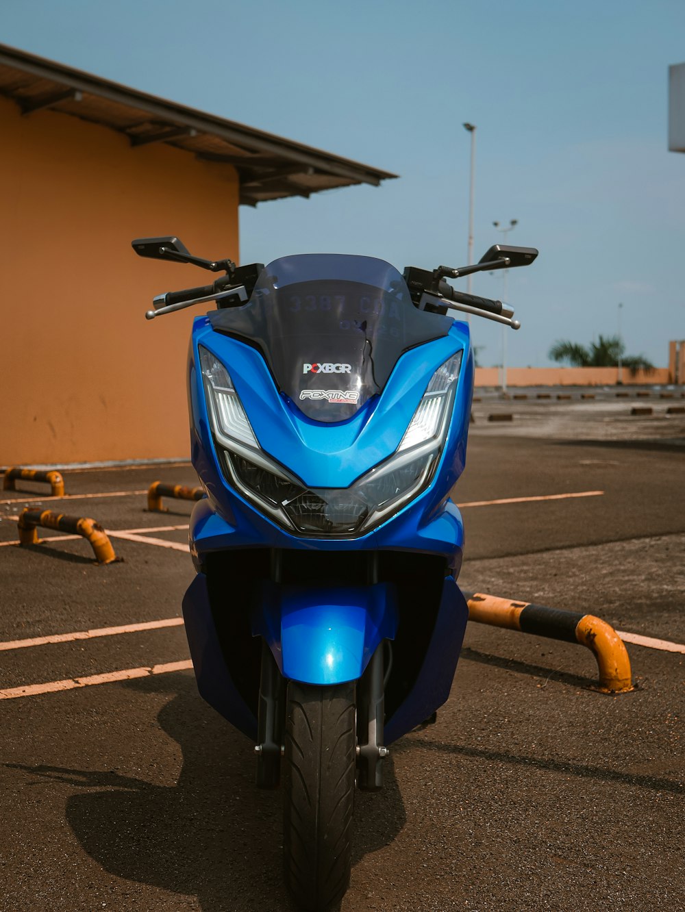 a blue motorcycle parked in a parking lot