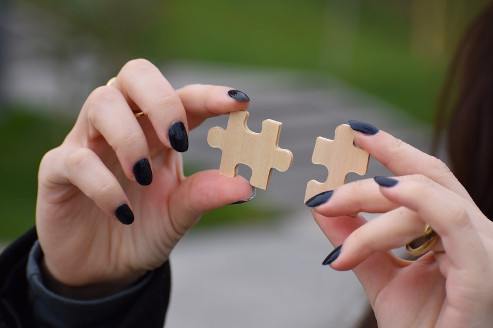 a person holding a pair of nails