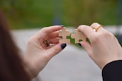 Close-up of hands holding a puzzle piece, symbolizing connection and support for special needs children.