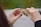 Close-up of hands holding colorful puzzle pieces fitting together.