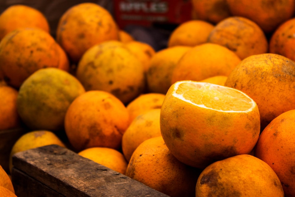 a bunch of oranges in a basket