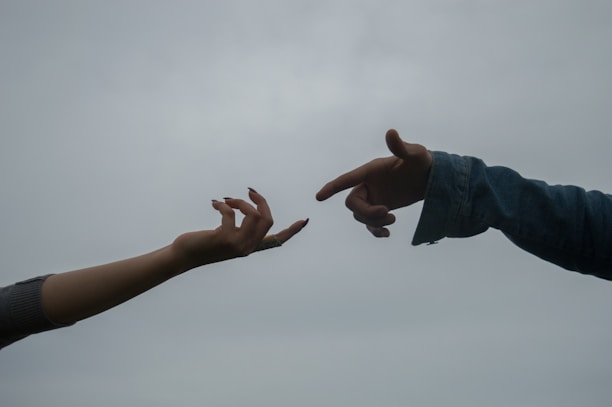 a pair of hands reaching out to each other