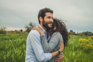 a man hugging a woman in a field
