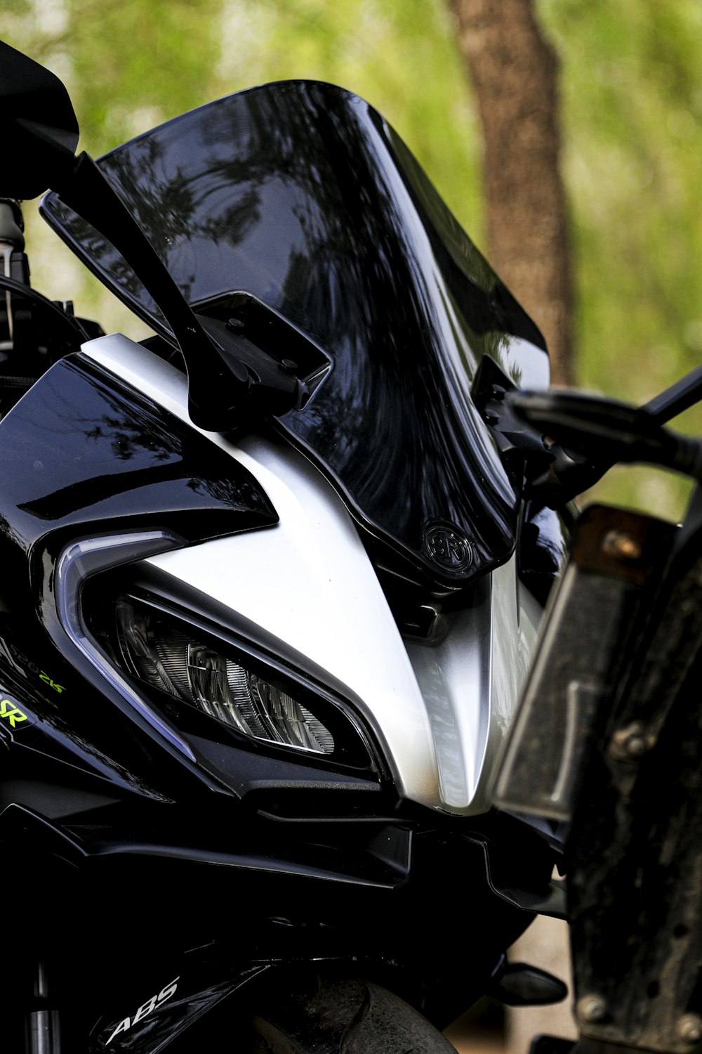 a motorcycle parked next to a tree