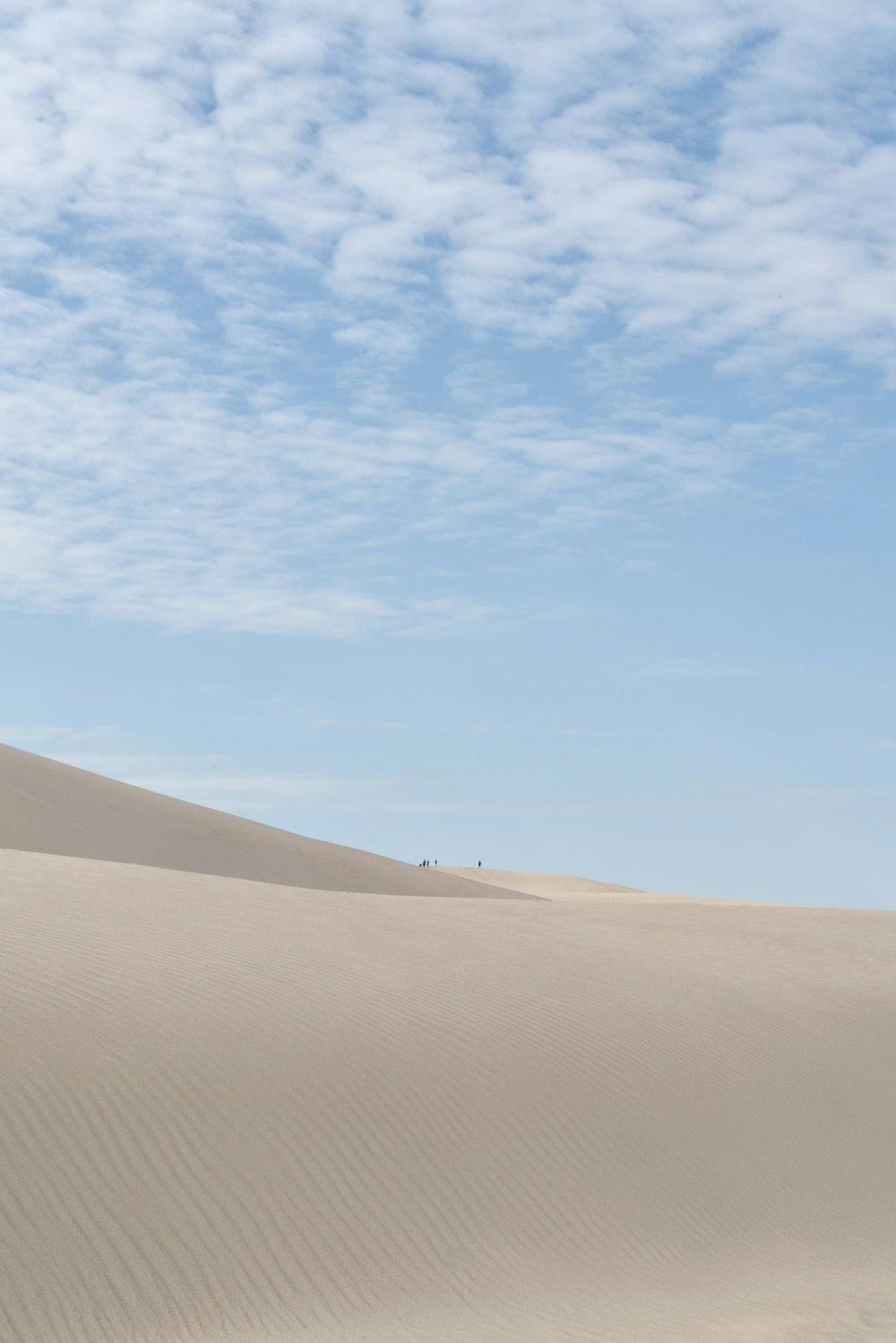 a sandy desert with a blue sky