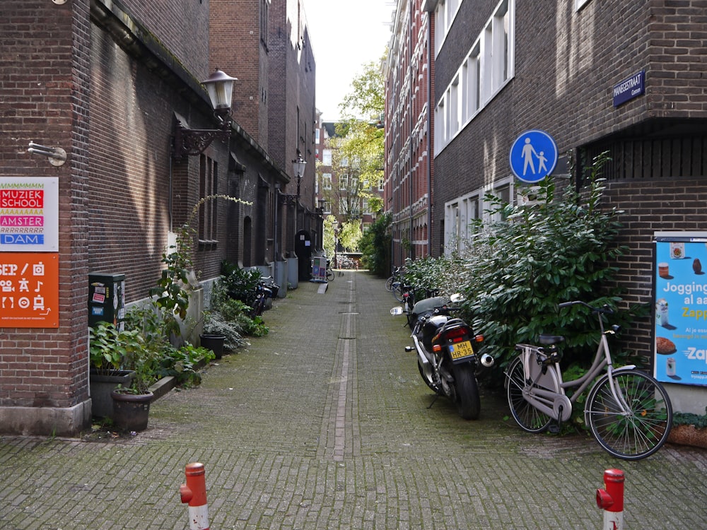 a bicycle and a motorcycle parked on a sidewalk