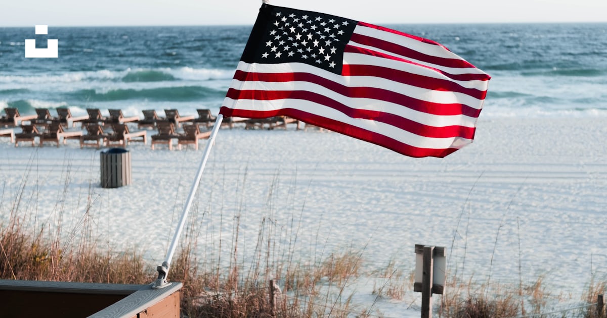 A flag on a beach photo – Free Panama city beach Image on Unsplash