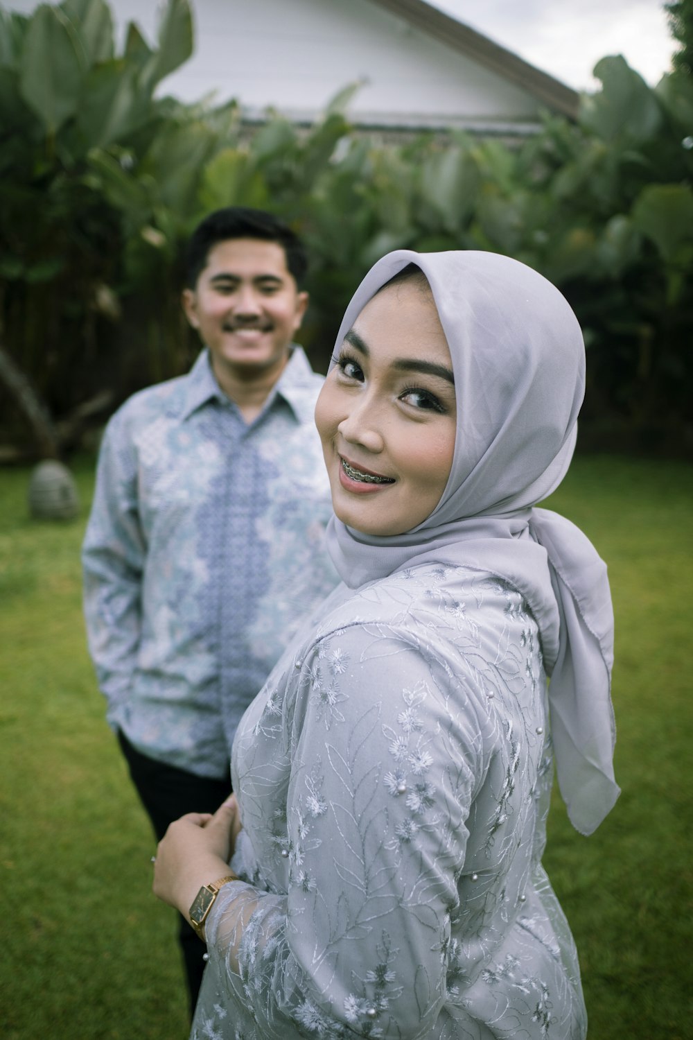 a man and woman standing together outside