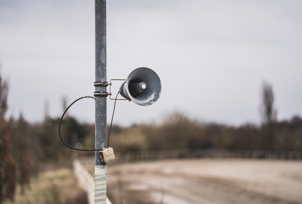 a black and white camera on a pole