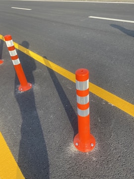 Close-up of freshly painted road markings on a busy highway at sunrise.