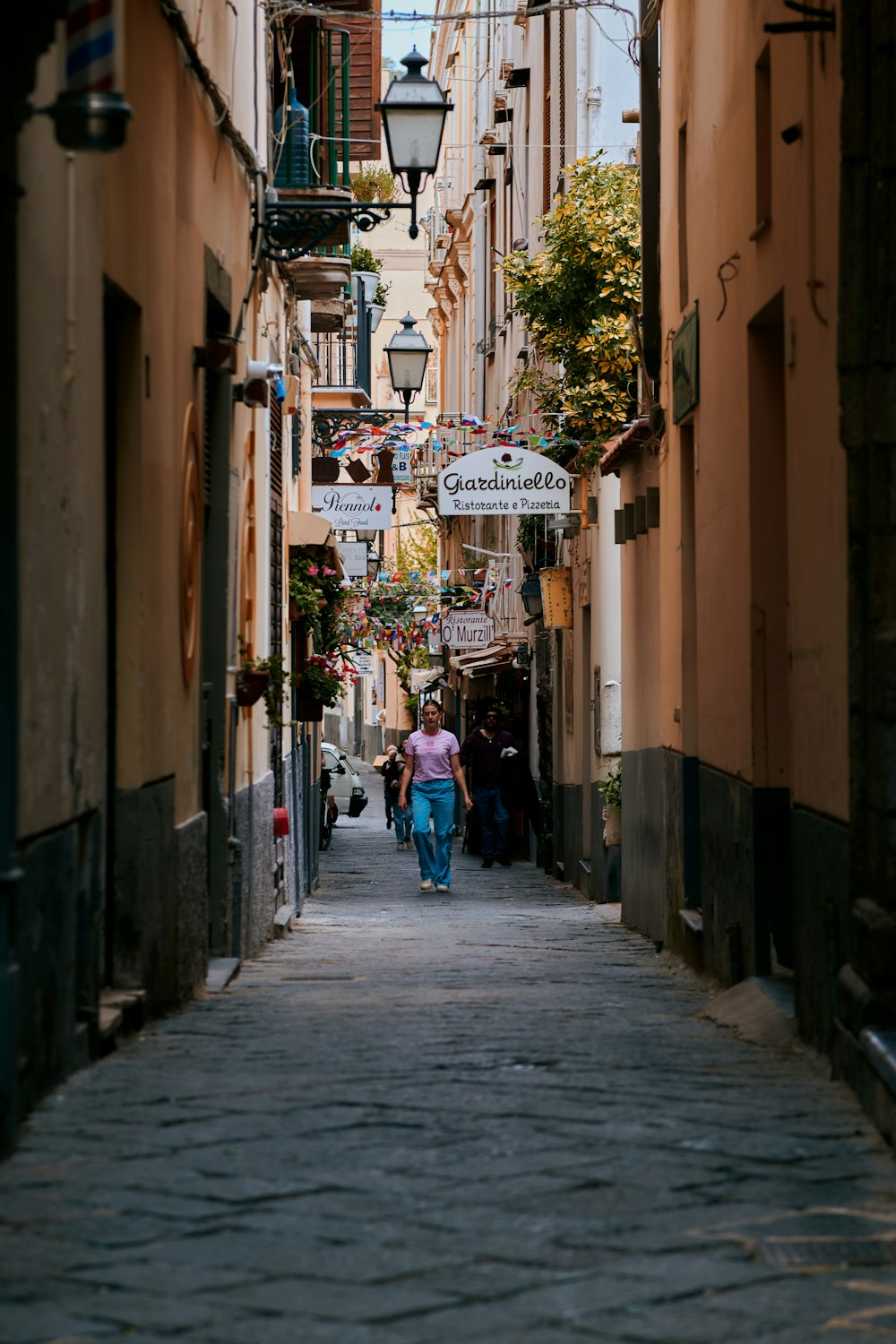 a person walking down a narrow street