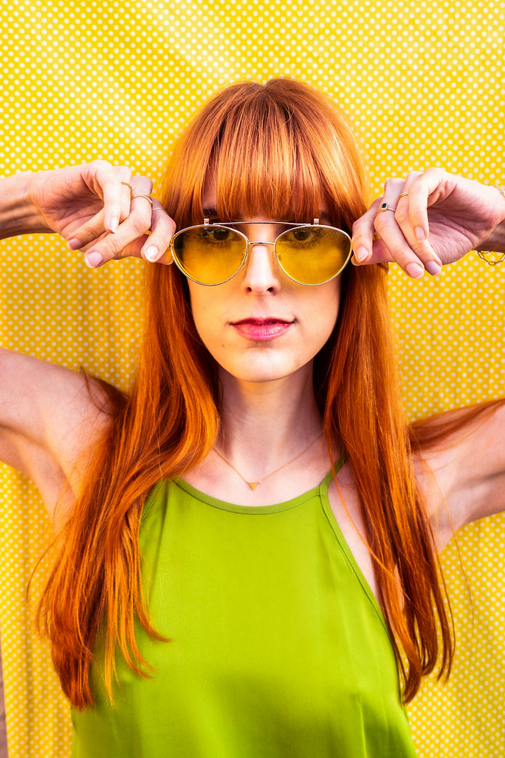 a woman wearing sunglasses posing for the camera