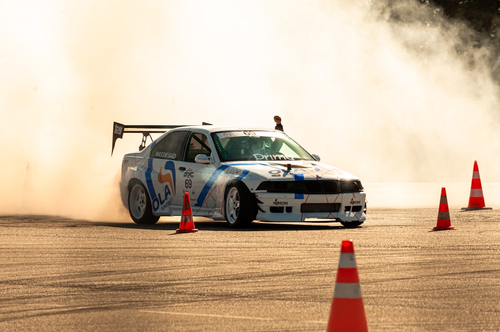 a race car driving around cones