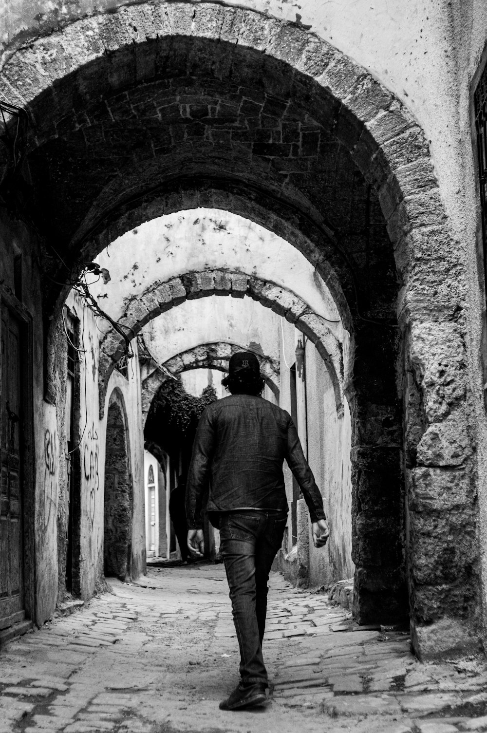 a man walking through an old building