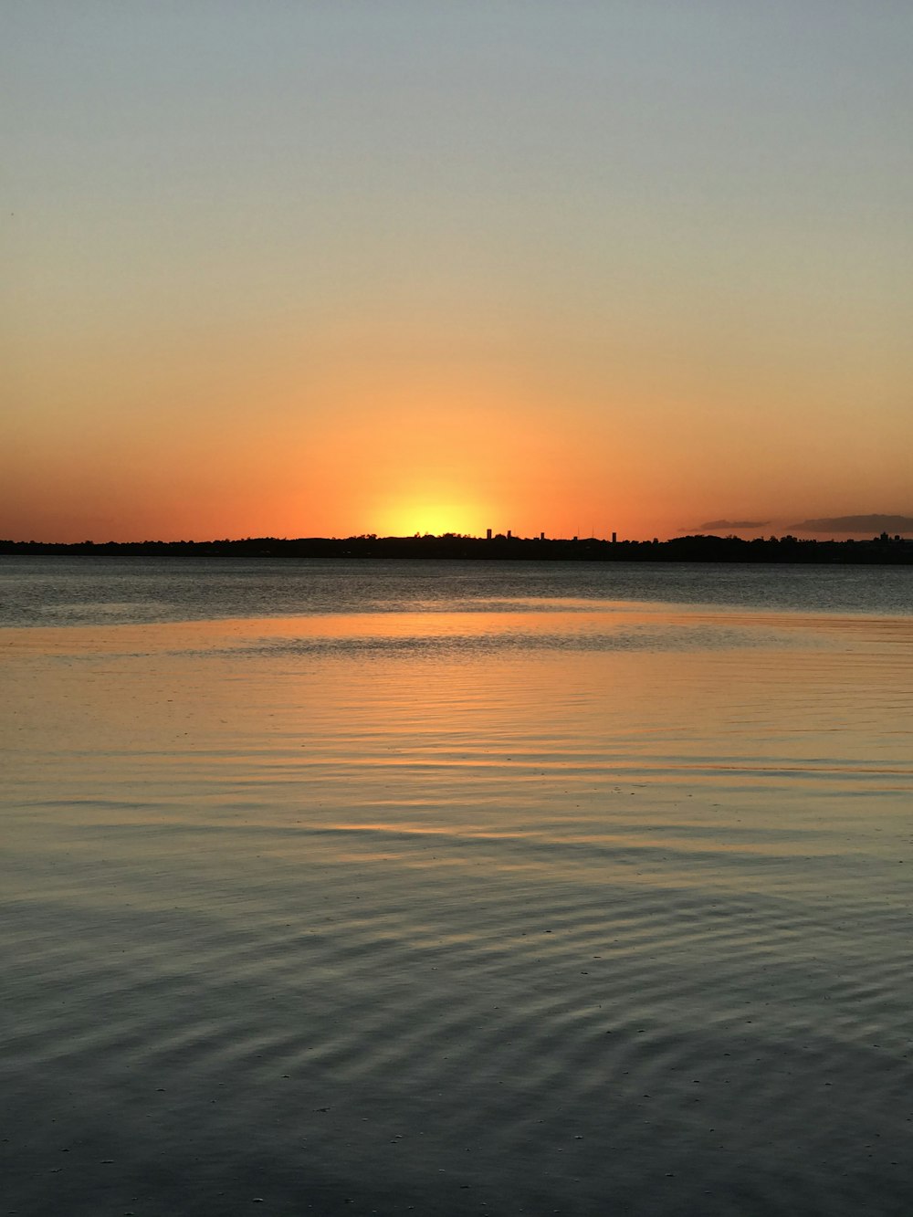 a sunset over a body of water