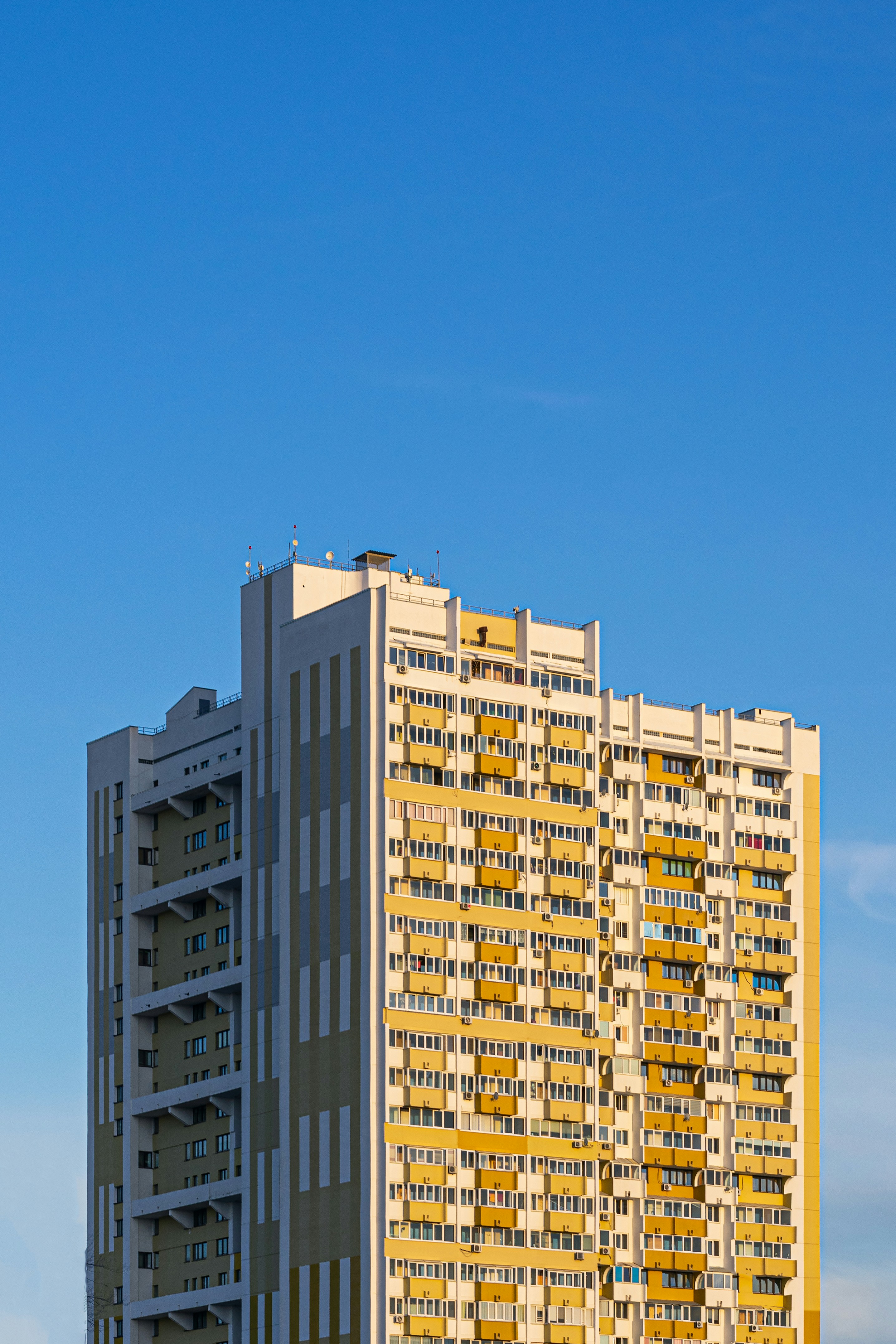 Yellow building / Windows / Sky / Cloudy / Sunshine