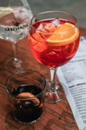 a couple of glasses with red liquid