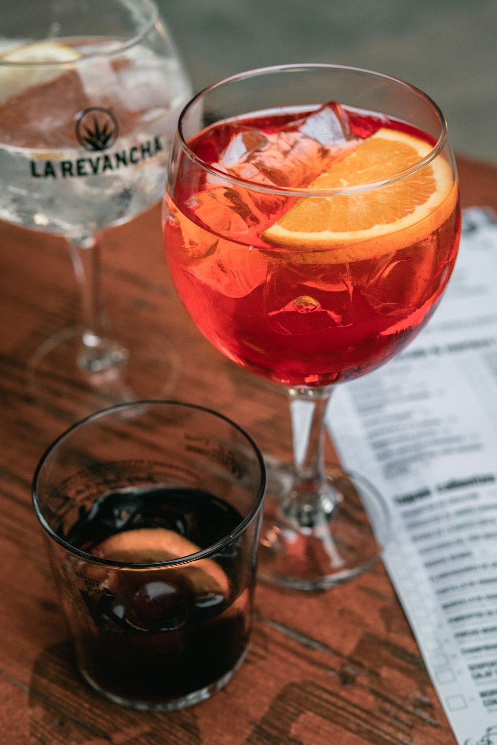 a couple of glasses with red liquid