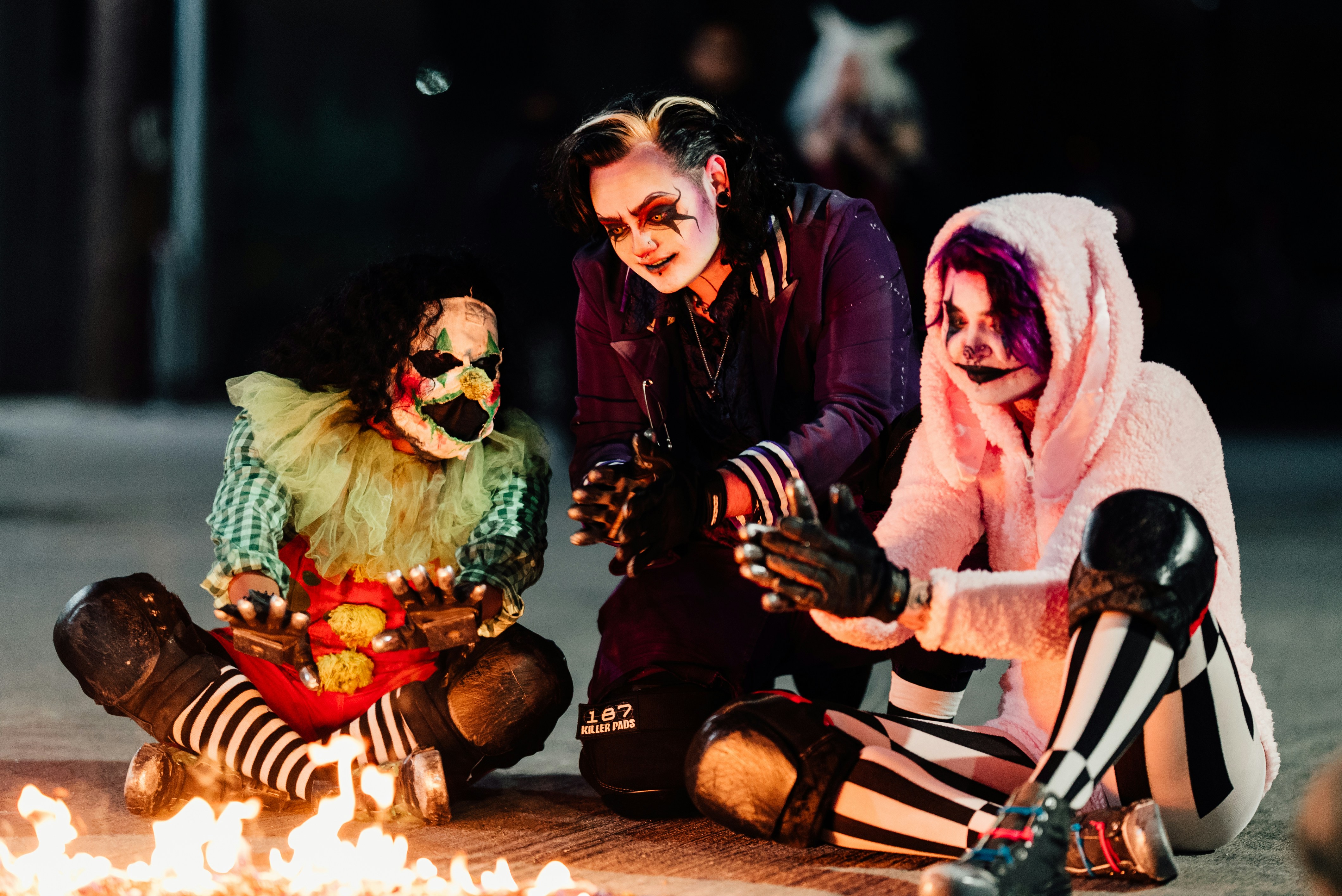 a man and woman kneeling next to a tiger in a garment