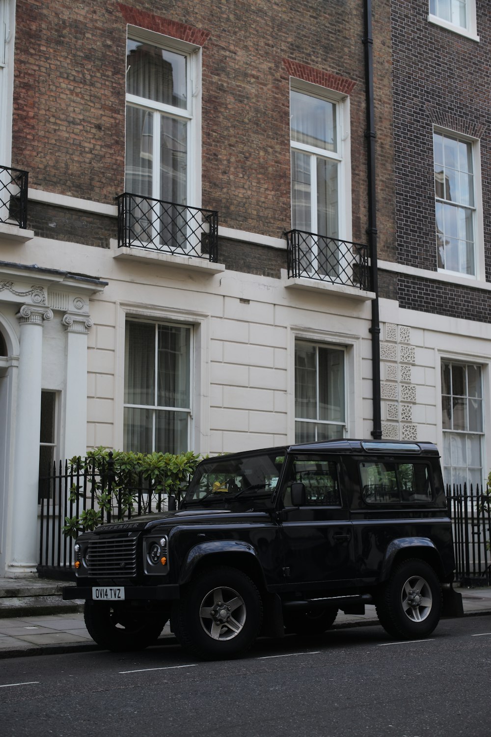 a black truck parked in front of a brick building