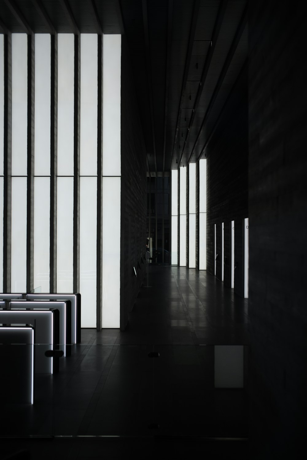 a dark hallway with white walls
