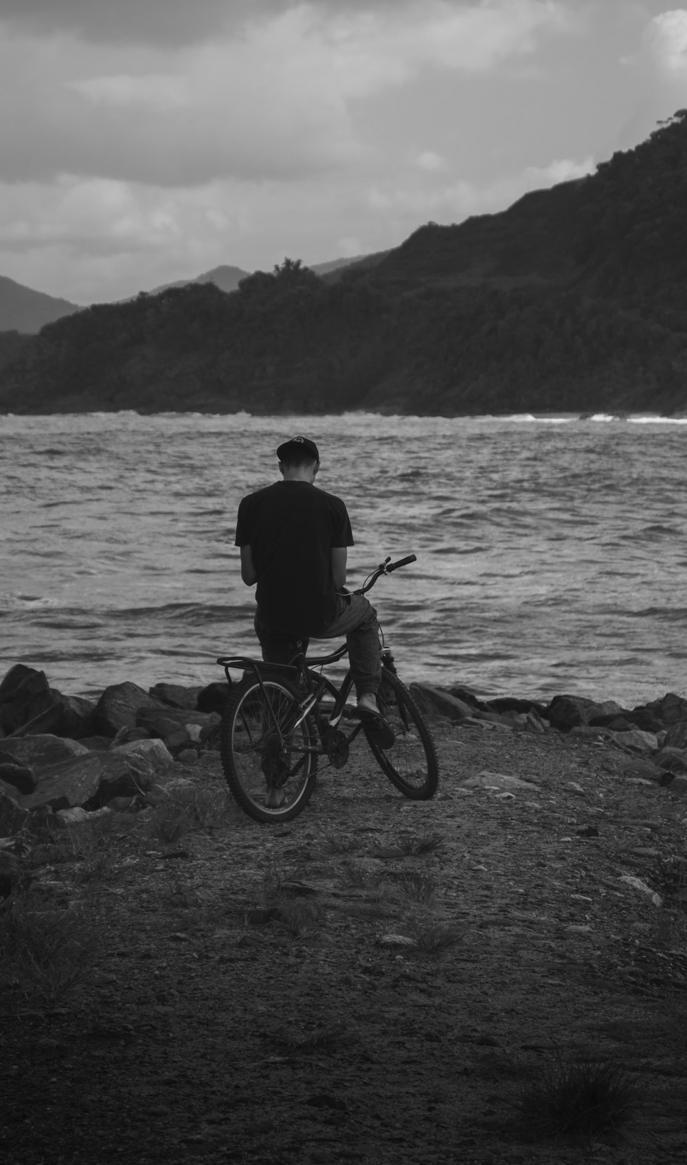 a man riding a bicycle on a beach